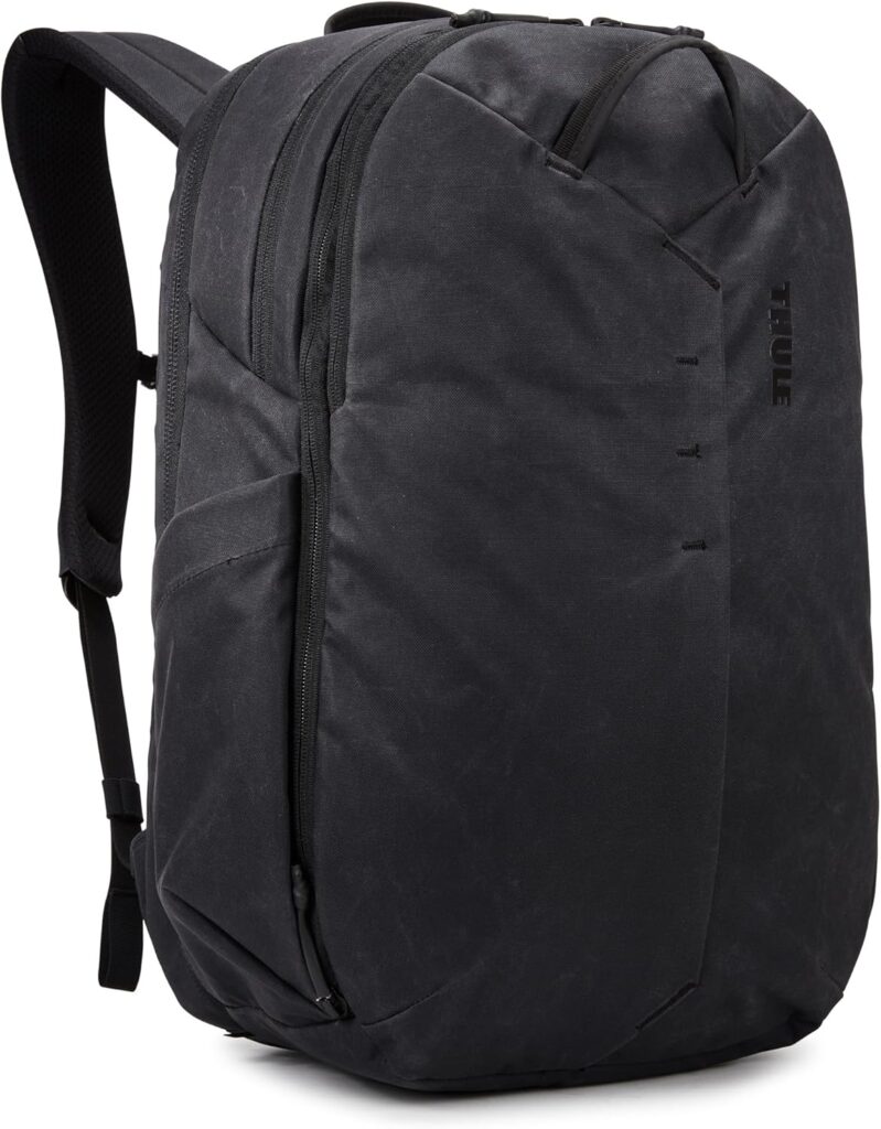 Black Thule backpack, ideal for travel for business, with sleek design and comfortable shoulder straps.