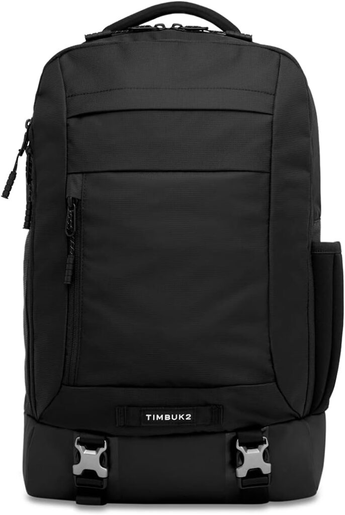 Black Timbuk2 business travel backpack with multiple compartments and buckle closures. Timbuk2 logo visible.