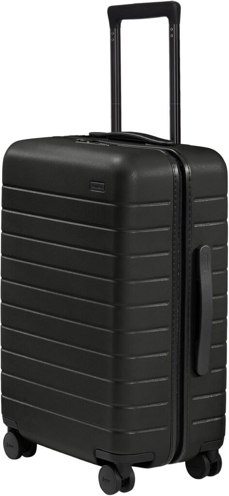 Black Away carry-on suitcase with extended handle, ideal expandable luggage for business or leisure travel.