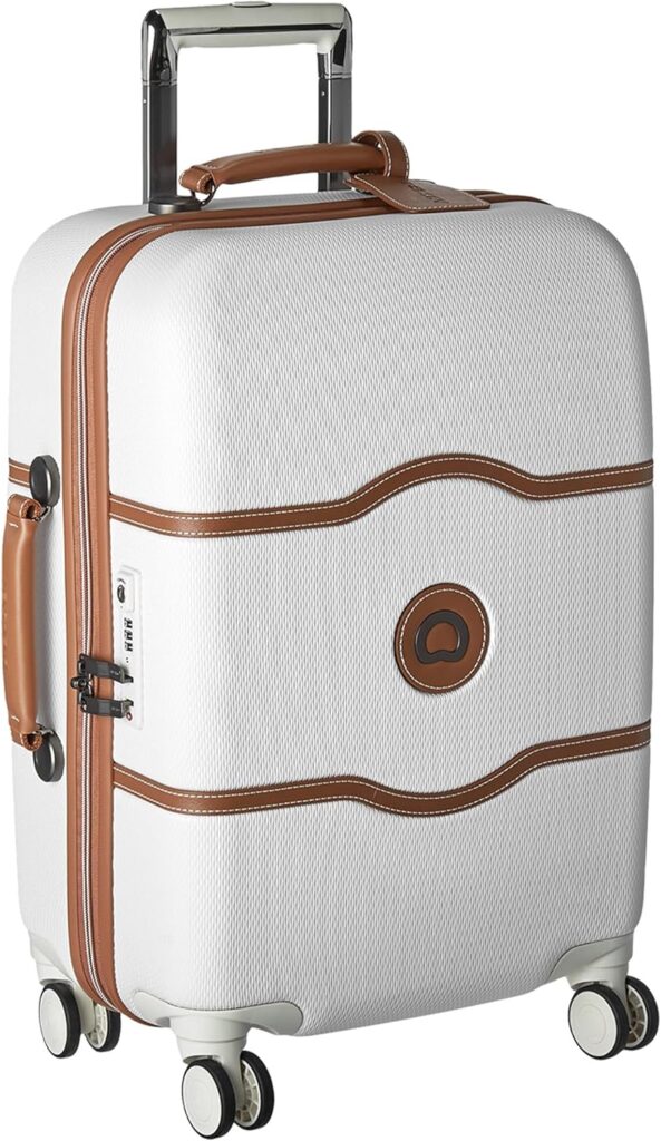White rolling carry-on suitcase with brown leather accents and a telescoping handle.